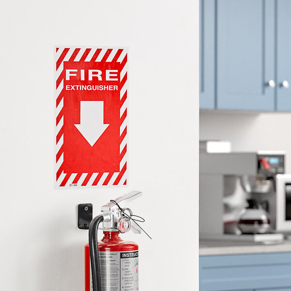 A Buckeye Fire Extinguisher adhesive sign on a wall above a fire extinguisher.