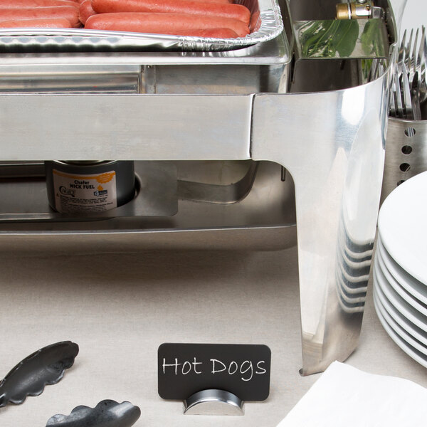 A Tablecraft stainless steel semicircle card holder on a table holding cards.