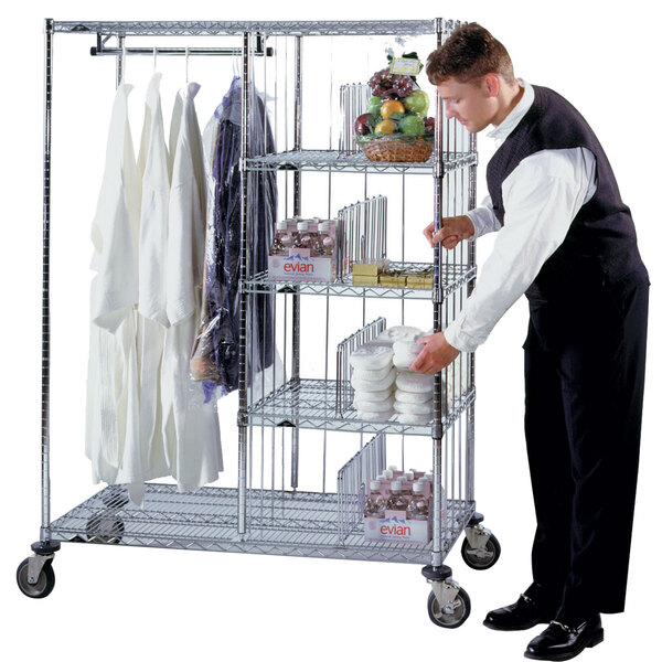 A man standing next to a Metro laundry cart full of towels.