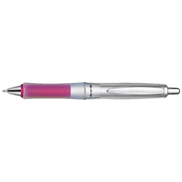 A close-up of a Pilot Dr. Grip Center of Gravity ballpoint pen with a silver and pink barrel and a red tip.
