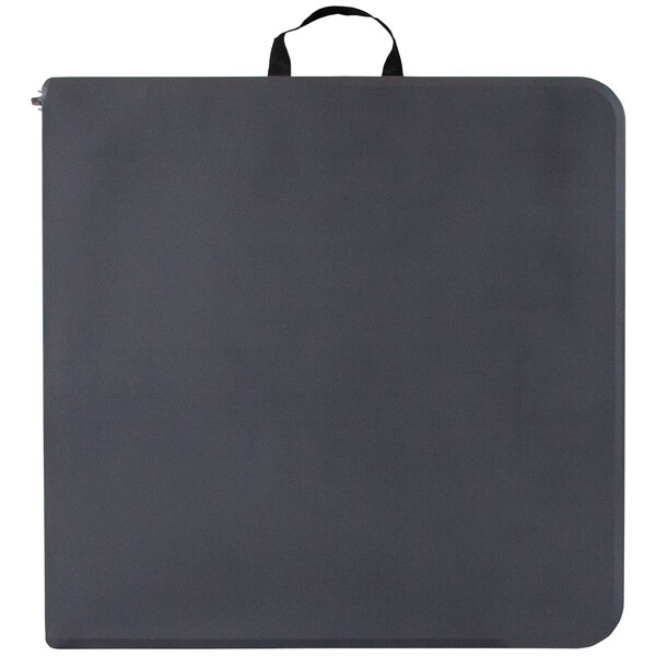 A rectangular dark gray plastic folding table with black straps on it.
