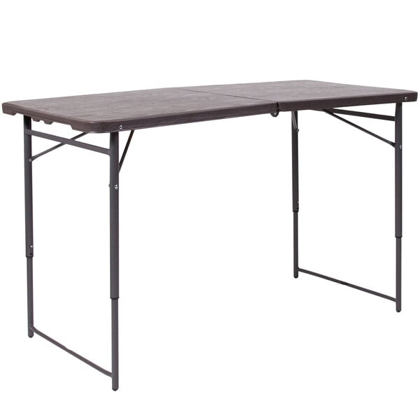 A Flash Furniture rectangular brown wood grain plastic folding table with legs.