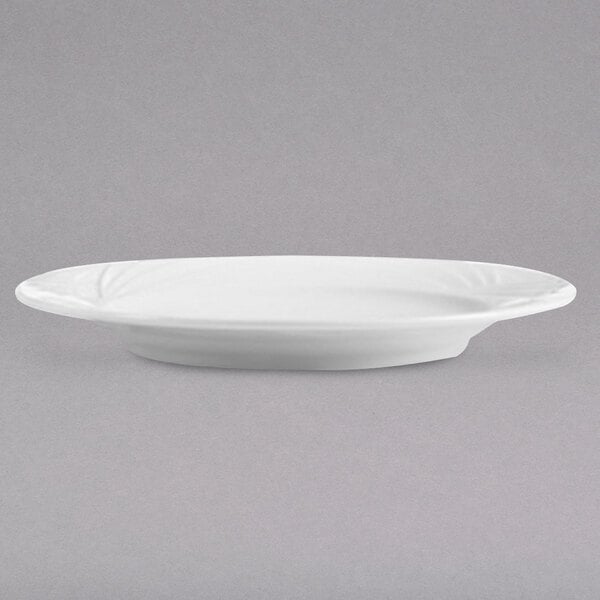An Arcoroc white porcelain brunch plate with a rim.