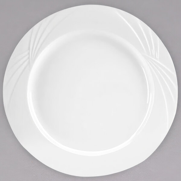 An Arcoroc white porcelain dinner plate with a swirl design.