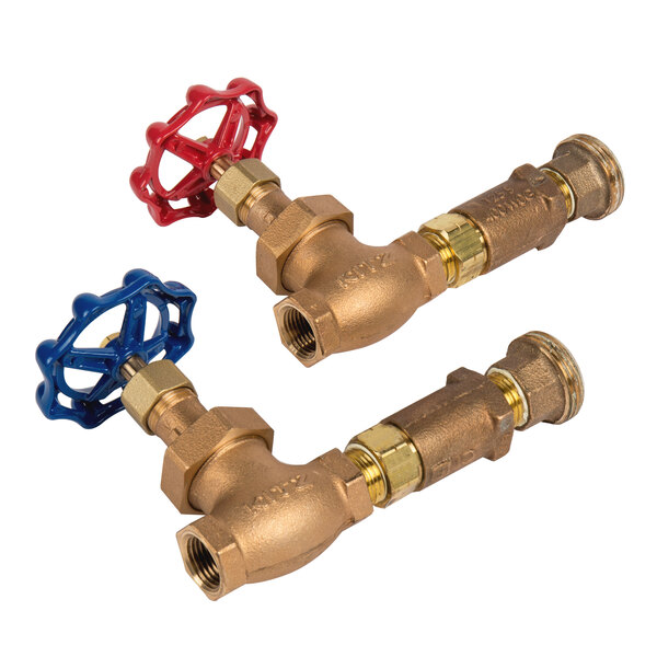 A T&S Brass wall mounted mixing valve assembly with red and blue handles on brass pipes.