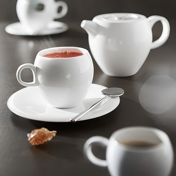 A Chef & Sommelier stainless steel coffee spoon on a white plate.