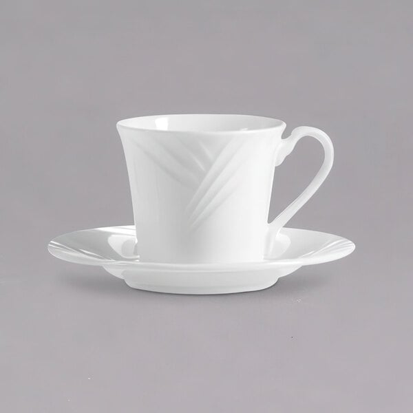 A close up of an Arcoroc white porcelain saucer with a white cup on a white surface.