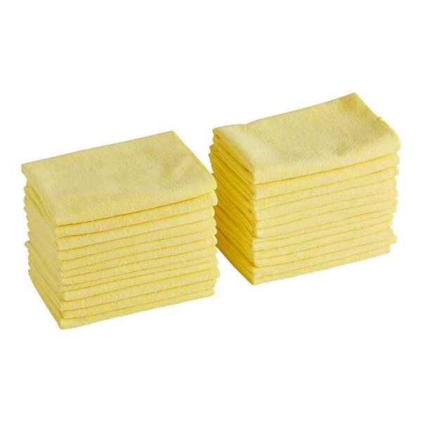 A set of yellow microfiber cleaning cloths stacked in two piles.