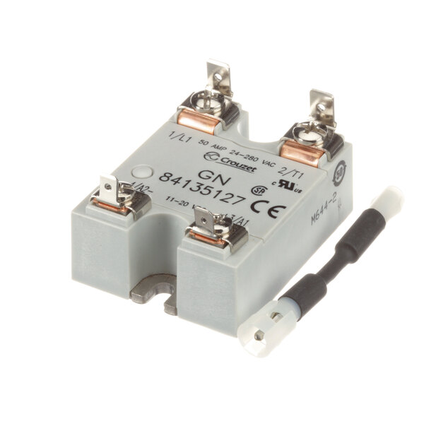 A close-up of a Newco relay, a white rectangular device with a black wire.
