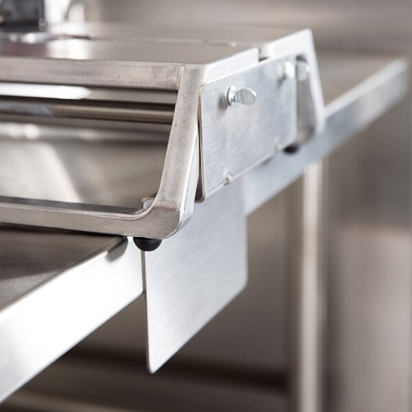 A Vollrath Redco InstaSlice fruit and vegetable cutter on a metal counter.