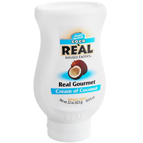 A white plastic container of Coco Real Cream of Coconut with a blue and white label.