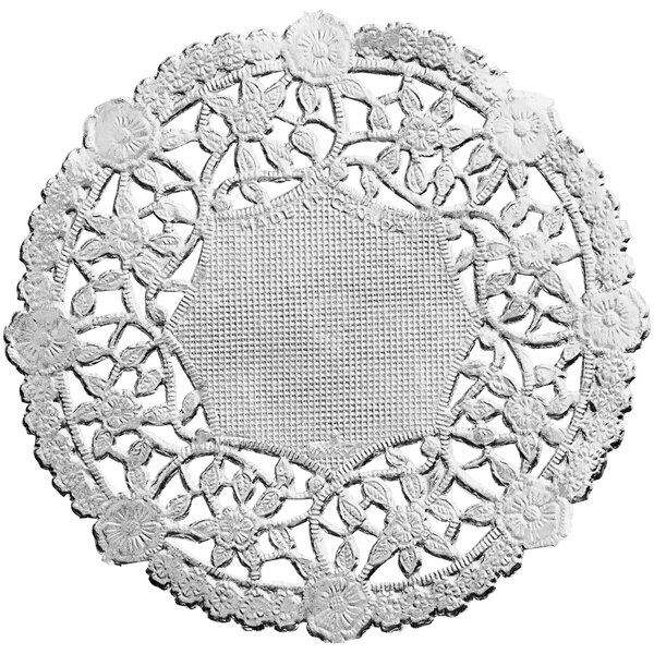 A close-up of a 4" silver foil lace doily with flowers on it.