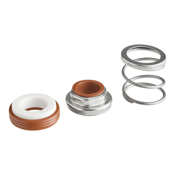 Three separate mechanical components are shown: a coiled metal spring, a metal and rubber ring, and a white and brown rubber-like ring, all arranged in a row on a white background.