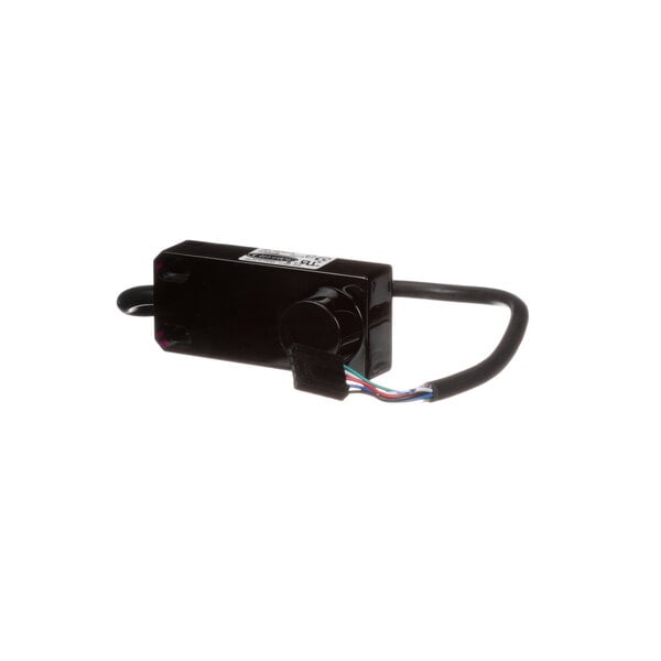 A black electronic device with wires attached.