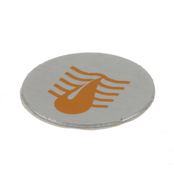 A round silver circular magnet with a yellow logo on it.