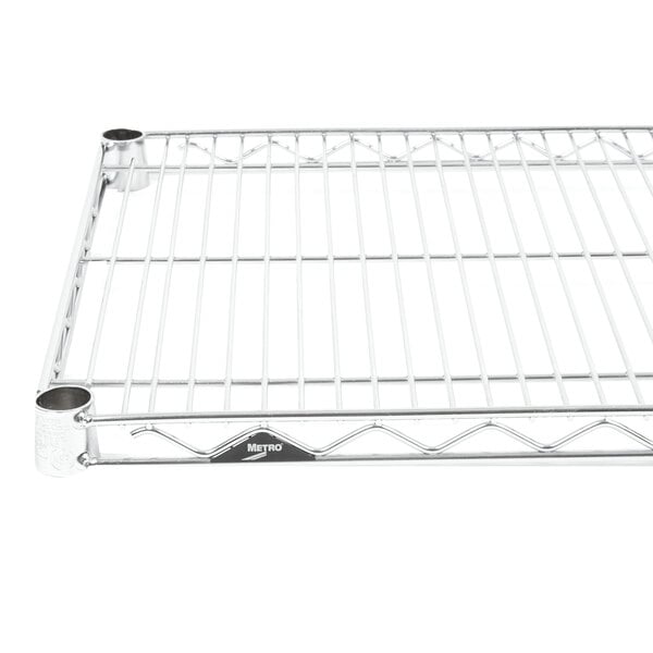 A Metro stainless steel wire shelf with a metal base and two holes.