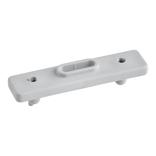 A rectangular, light gray plastic component with two holes and a raised oval slot in the center, featuring two pegs on the underside.