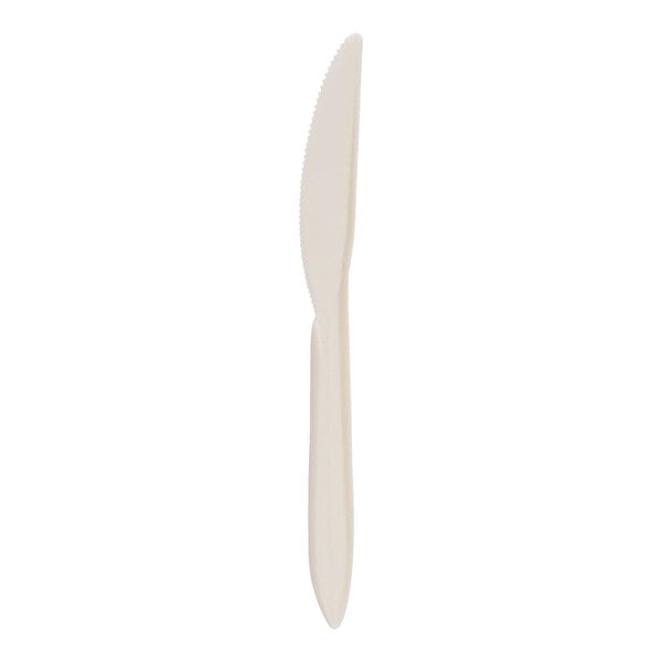 A single beige plastic knife with a serrated edge is shown against a white background.
