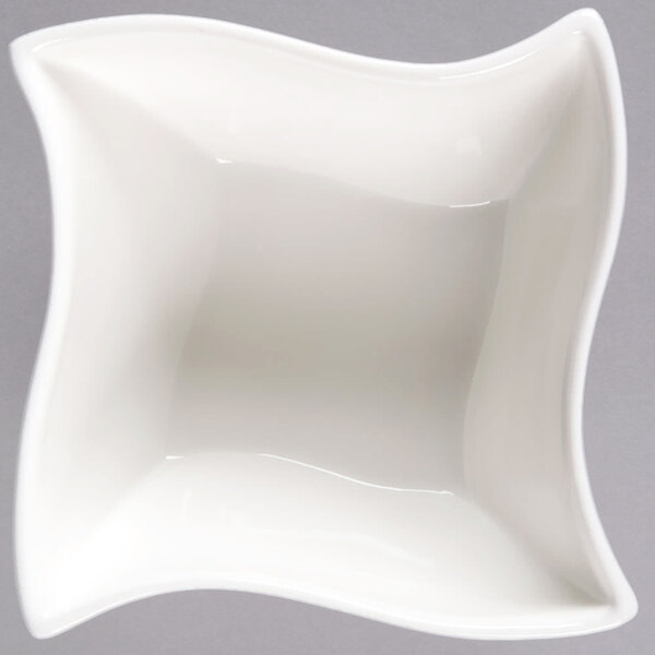 An American Metalcraft Prestige white porcelain bowl with a wavy edge.