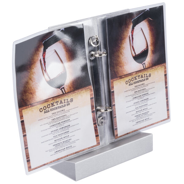 A brushed aluminum Menu Solutions menu tent holding a menu on a table.