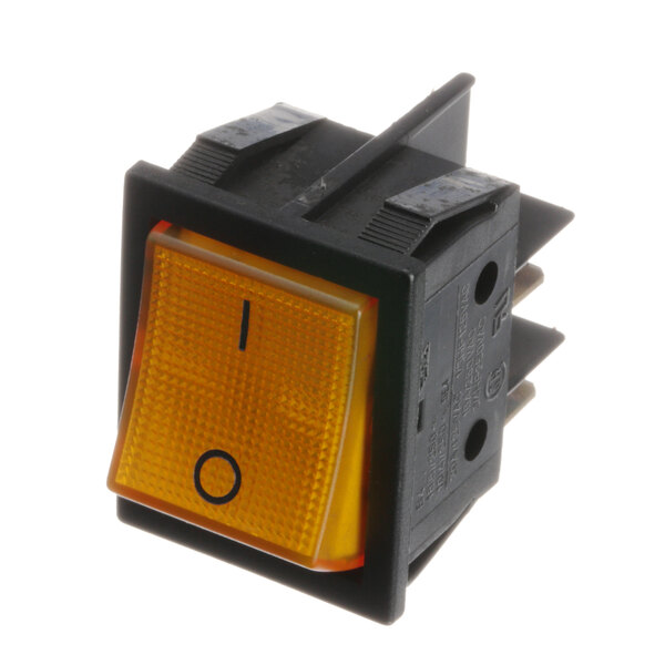 A close-up of a black and yellow Quality Espresso switch with a light.