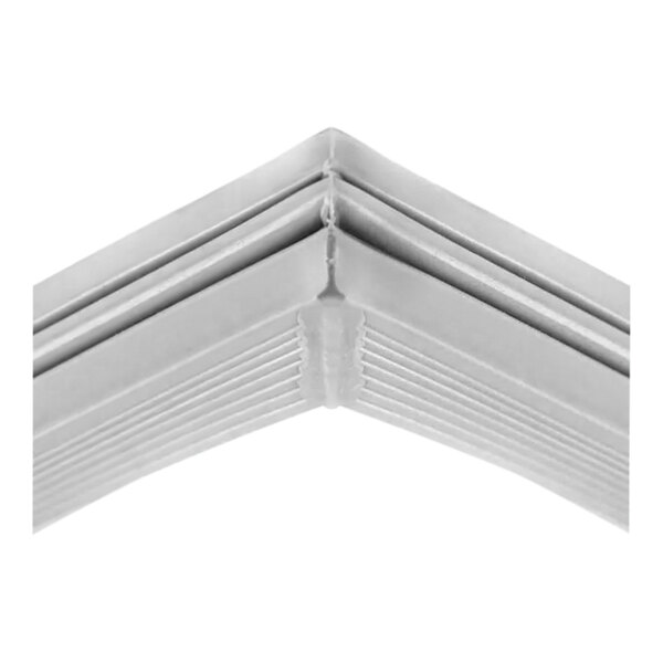 A close up of a silver corner trim on a white object.