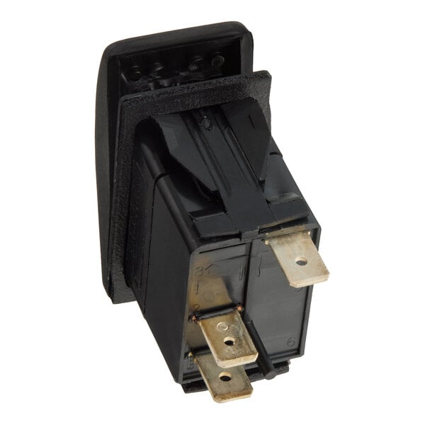 A black rectangular electrical switch with three metal prongs and a foam gasket, viewed from the back.