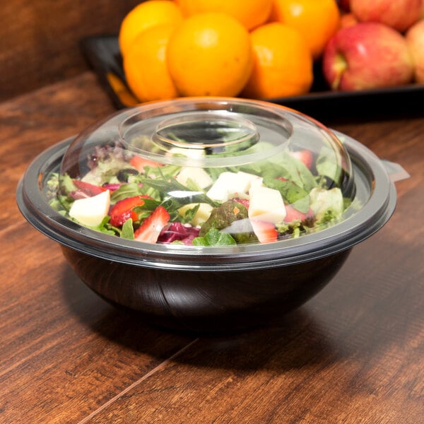 A clear plastic dome lid on a salad bowl.