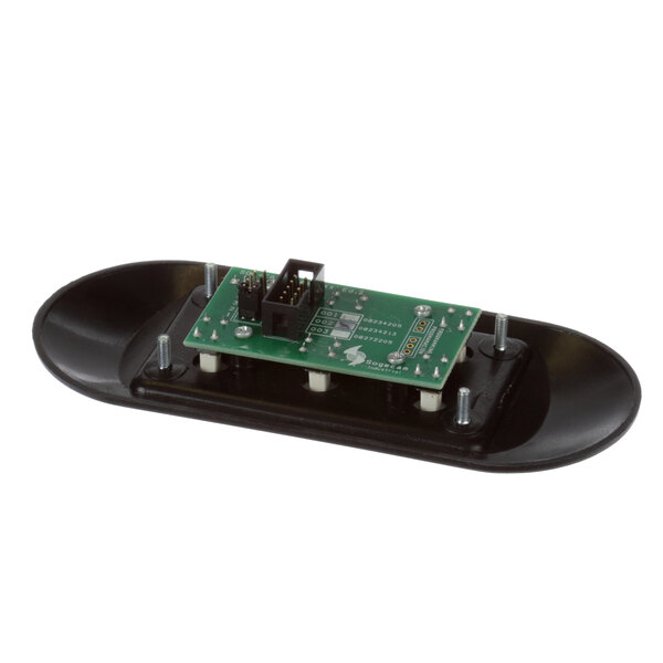 A green circuit board on a black oval object.
