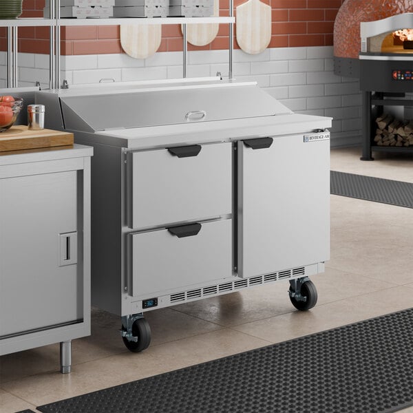A stainless steel 48-inch refrigerated sandwich prep table with one door and two drawers on casters.