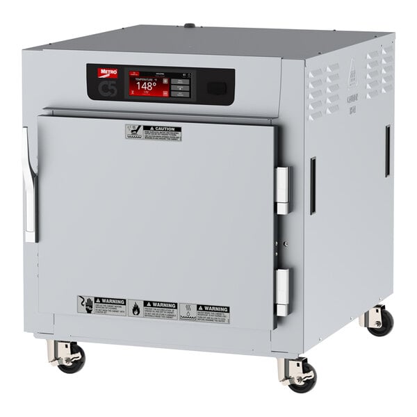 A white rectangular Metro C5 heated holding cabinet on wheels.
