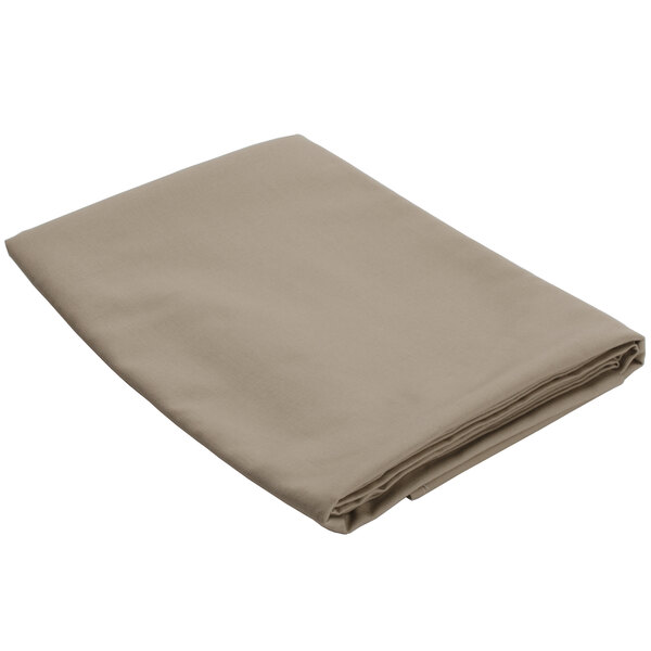 A folded beige table cover on a white background.