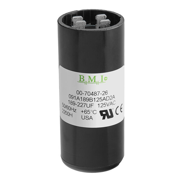 A black round capacitor for a Hobart meat slicer with a white label.