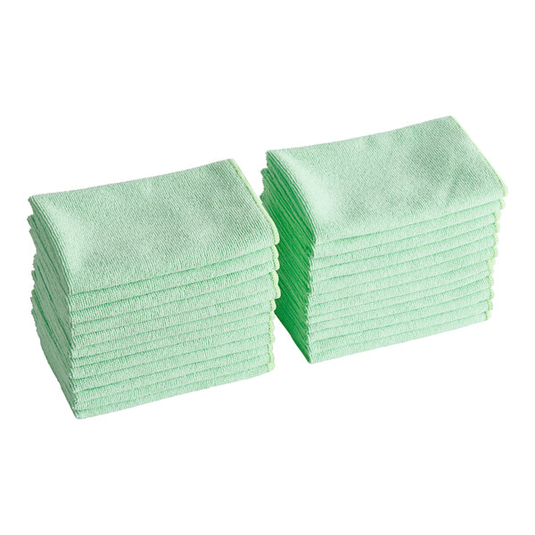 A set of green microfiber cleaning cloths stacked in two piles.