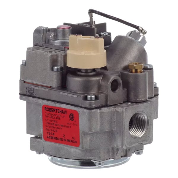 A metal gas control valve with various fittings and a red label, used for Frymaster equipment.