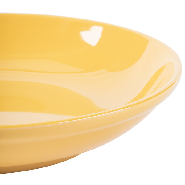 A close up of a yellow GET Diamond Mardi Gras tropical yellow melamine bowl.