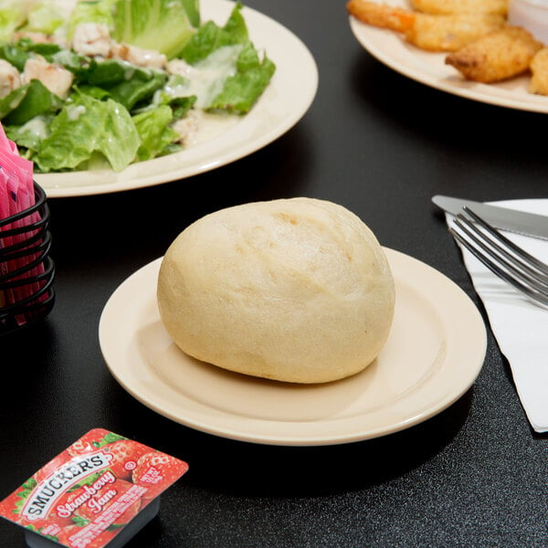 A Thunder Group Nustone Tan melamine plate with food on it.