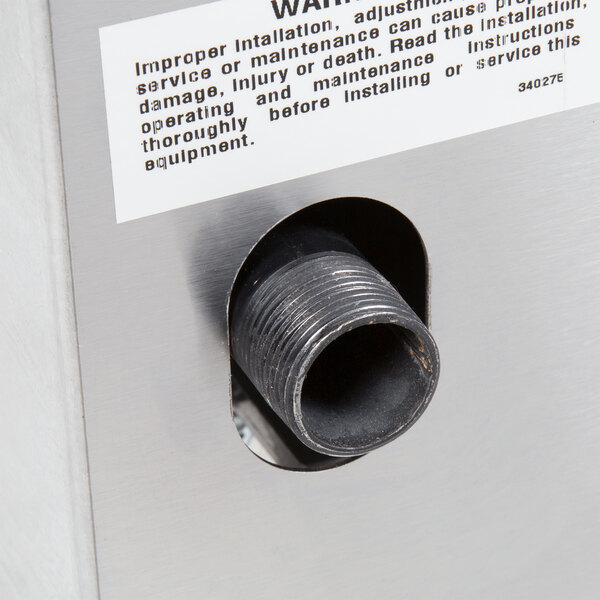 A close-up of an APW Wyott countertop range's warning label.