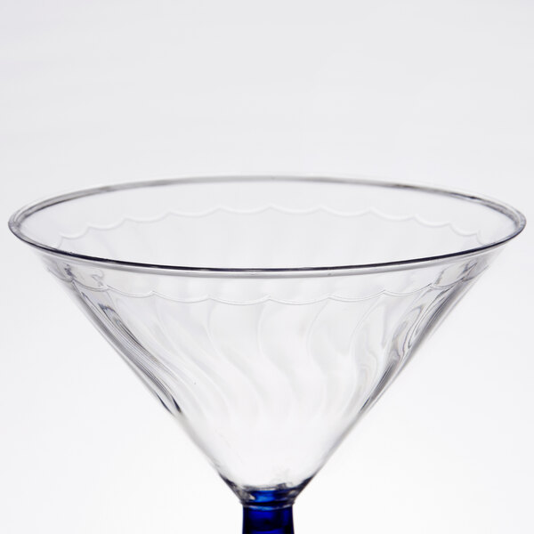 A clear plastic martini glass with a blue rim and base.