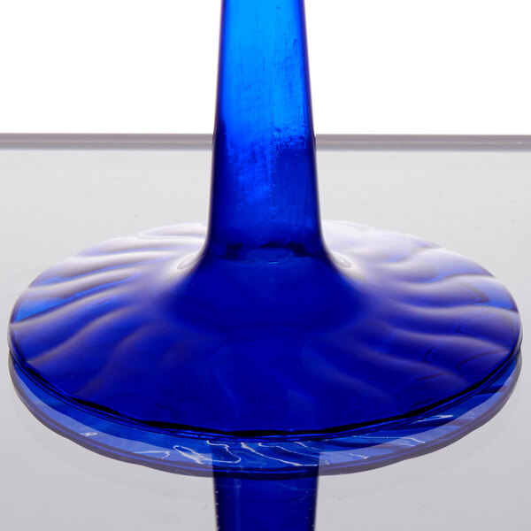 a blue glass stem on a table