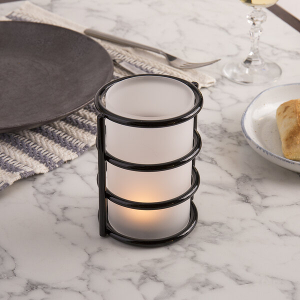 A black Sterno Epic metal candle holder on a table.