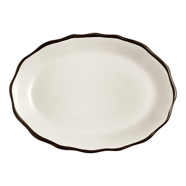 An ivory stoneware platter with a black scalloped edge.