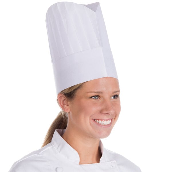 A woman wearing a white Royal Paper disposable chef hat.