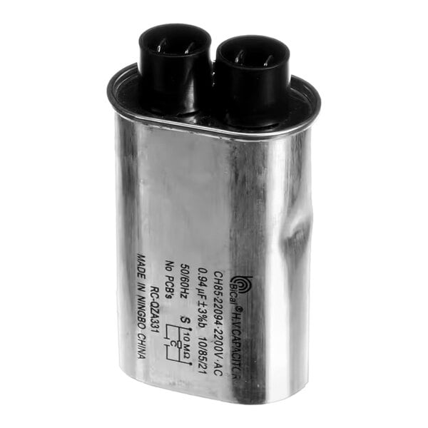 A metal high voltage capacitor with two black terminals on top.