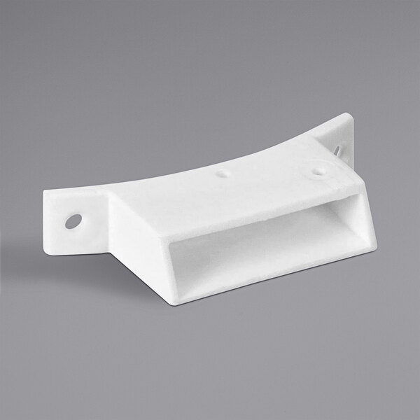 A white plastic switch housing with holes and a curved edge.