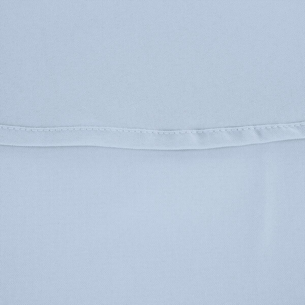 A close up of a light blue fabric with a white hem.