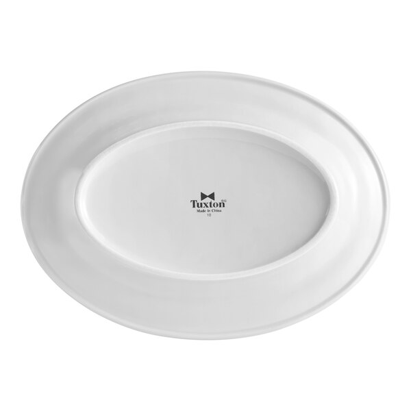 A white oval Tuxton china platter with a black logo.