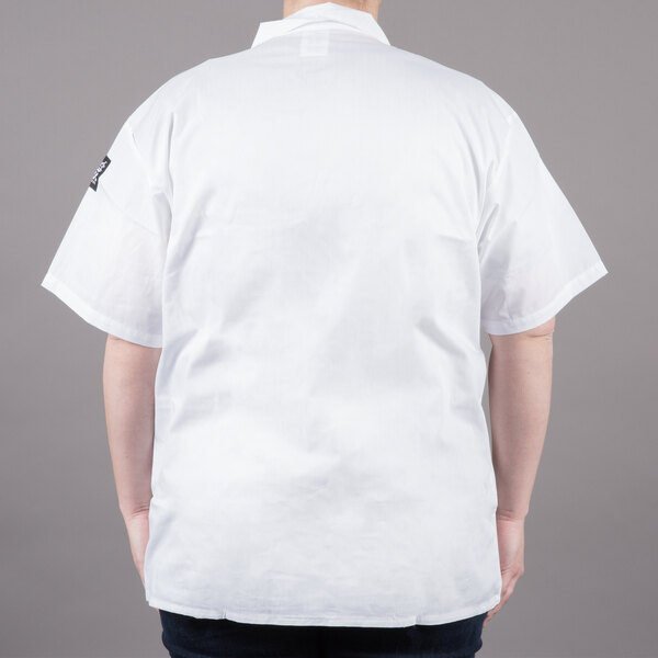 A man wearing a white Chef Revival cook shirt with short sleeves.
