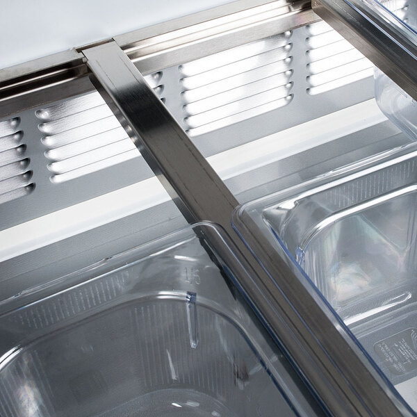 A Beverage-Air stainless steel refrigerator with two open glass lids.