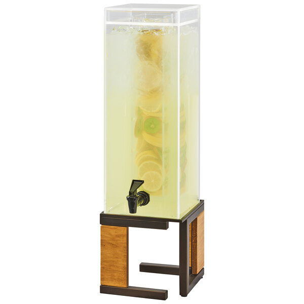 A Cal-Mil bronze metal and rustic pine beverage dispenser with an infusion chamber on a wooden stand.